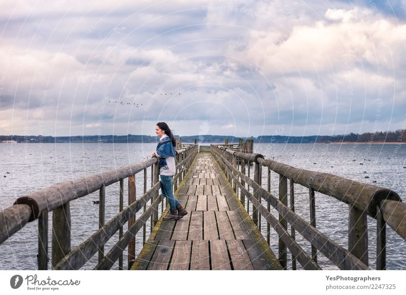 Woman relaxing on a bridge in nature Vacation & Travel Tourism Freedom Winter Nature Water Horizon Lake Peaceful Loneliness Bavaria Lake Chiemsee Germany