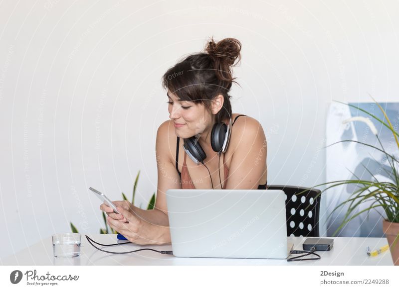 Businesswoman working on her laptop at work ( star-up concept ) Lifestyle Happy Desk Success Work and employment Workplace Office Company Cellphone Computer