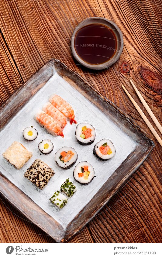 Sushi set on pottery plate with chopsticks and soy sauce Food Seafood Lunch Plate Table Wood Rust Fresh Delicious Above Tradition ceramic Chopstick Cooking