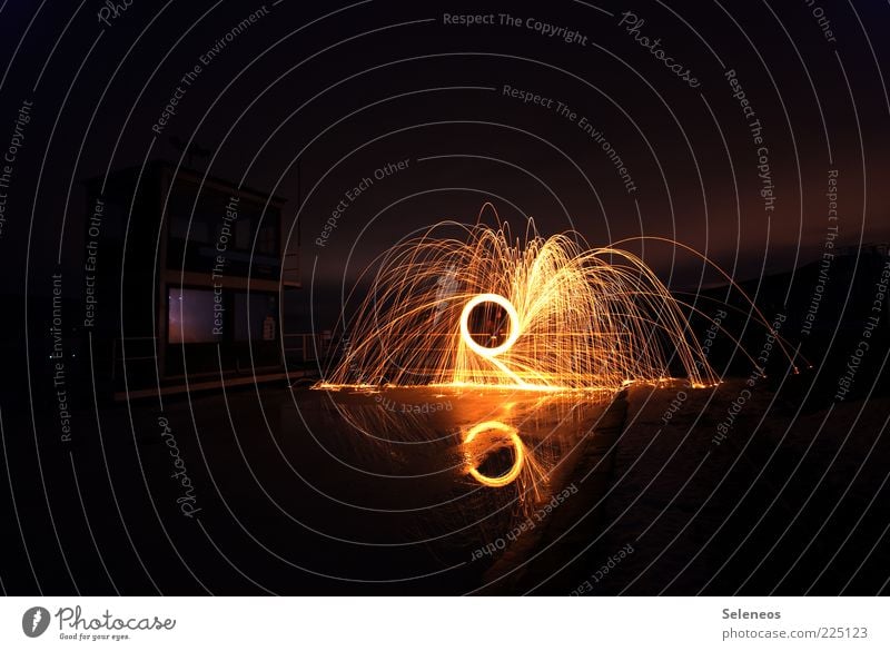 drizzle Water Pond Lake Brook Rotate Glittering Illuminate Energy Fire Burn Firecracker Colour photo Exterior shot Copy Space top Copy Space bottom Twilight