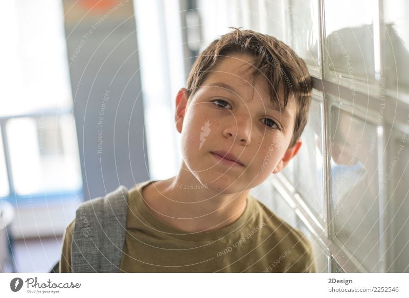 Portrait of a young student leaning on wall while looking camera Lifestyle Leisure and hobbies Child School Schoolchild To talk Telephone Cellphone PDA