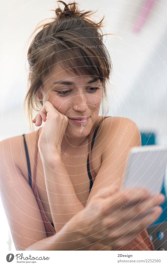 Happy young businesswoman using mobile phone in office Lifestyle Reading Study Work and employment Profession Workplace Office Business Telephone PDA Computer