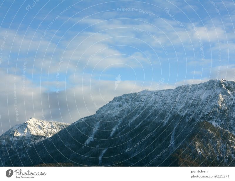 View of the Bavarian mountains in front of clouds and sky Trip Winter Snow Mountain Rock Snowcapped peak Blue Sky Clouds Freedom Impressive Colour photo