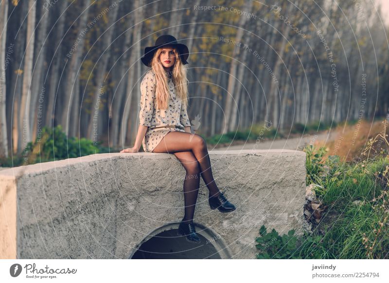 Portrait of blonde young woman with curly hair in a rural road wearing dress, Beautiful Hair and hairstyles Human being Feminine Woman Adults 1 18 - 30 years