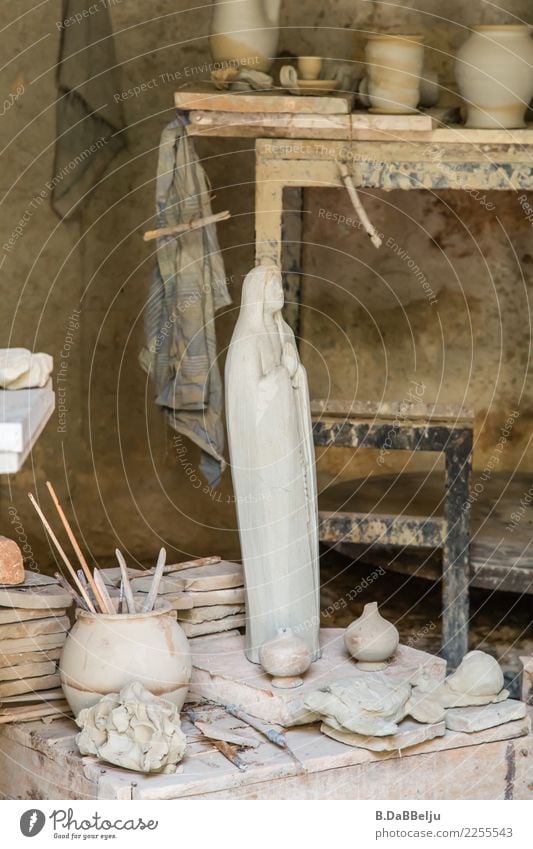 In the pottery workshop, the finished beautiful figure of a woman in a cape. Pottery workshop Art Sculpture Tone Deserted Arts and crafts Craft (trade)