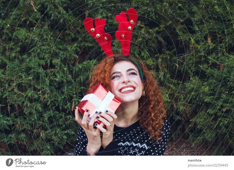 Young woman wearing winter clothes is holding a gift box Beautiful Wellness Life Feasts & Celebrations Christmas & Advent New Year's Eve Human being Feminine