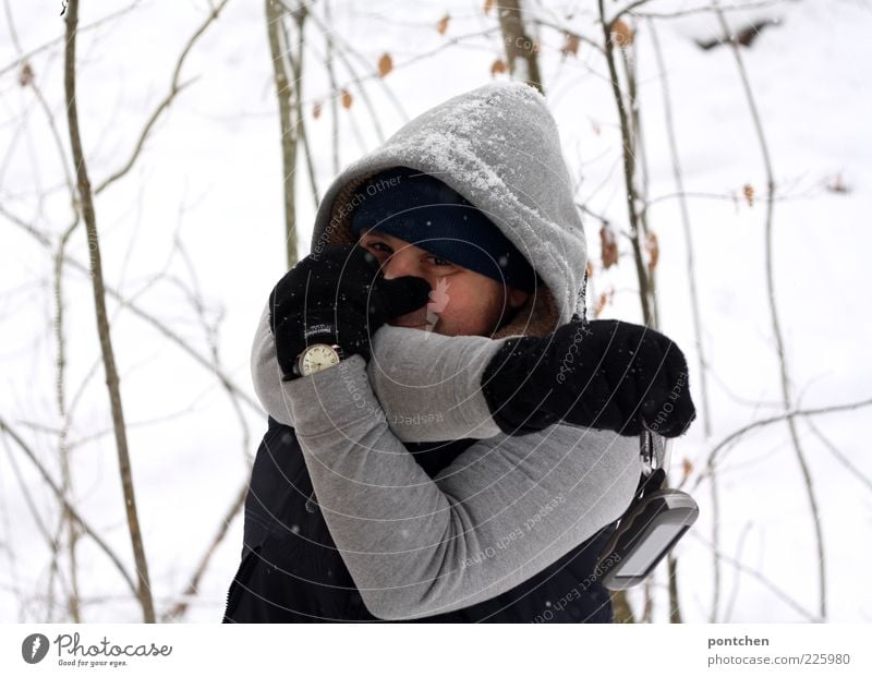 A man in winter clothing plays elephant and shapes his arms into a trunk. Winter. Humor Human being Masculine Young man Youth (Young adults) Man Adults 1