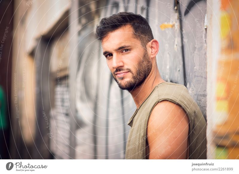 young handsome man with t-shirt against a wall in street Lifestyle Style Happy Human being Boy (child) Man Adults Town Street Fashion Jeans Cool (slang)