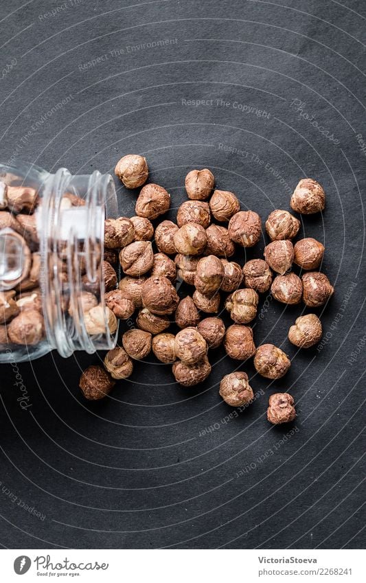 Hazelnuts spilling out of a jar. Close up . Top view. Fruit Nutrition Eating Breakfast Lunch Diet Lifestyle Design Healthy Health care Alternative medicine