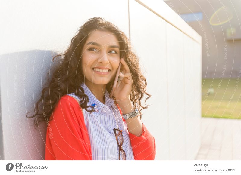 Pretty woman calling on phone walking in the street Joy Business To talk Telephone Cellphone PDA Woman Adults Youth (Young adults) Street Smiling Laughter