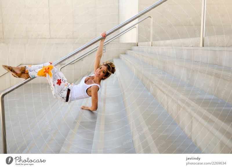 Funny blonde woman jumping in urban background. Joy Beautiful Human being Feminine Young woman Youth (Young adults) Woman Adults 1 18 - 30 years Fashion