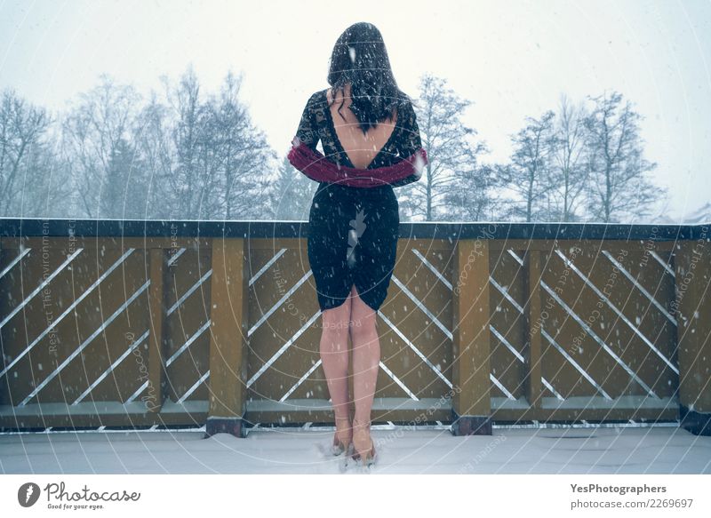 Sexy woman in black dress under snowfall Elegant New Year's Eve Young woman Youth (Young adults) Nature Snowfall High heels Think Sadness Loneliness