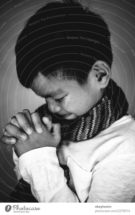 Closeup on a young boy pray, believe concept Lifestyle Reading Human being Man Adults Father Hand Fingers Book Library Church Suit Tie Paper Dark Black Hope