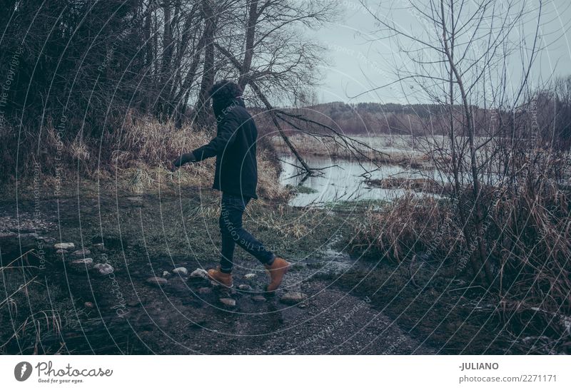 Young man is jumping on rocks to cross the river Leisure and hobbies Vacation & Travel Trip Adventure Winter Snow Winter vacation Human being Masculine