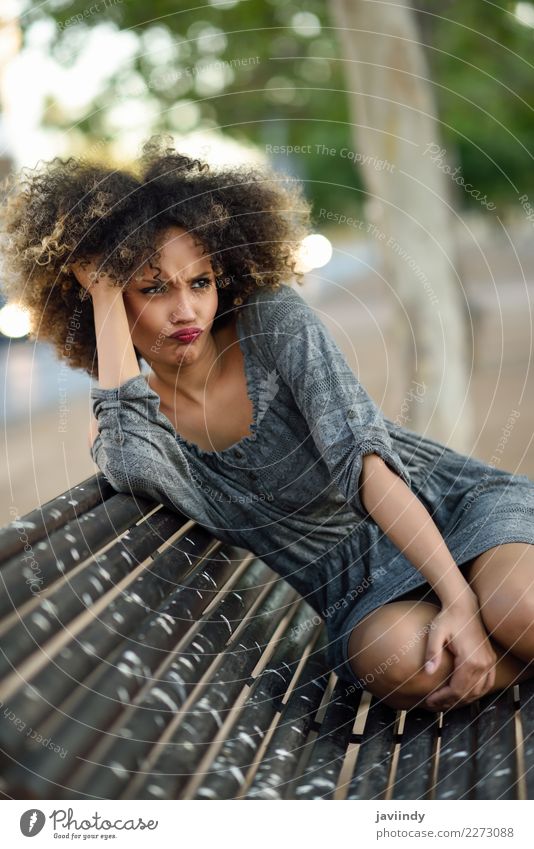 Funny black woman with afro hairstyle sitting on an urban bench Lifestyle Style Happy Beautiful Hair and hairstyles Face Human being Feminine Young woman