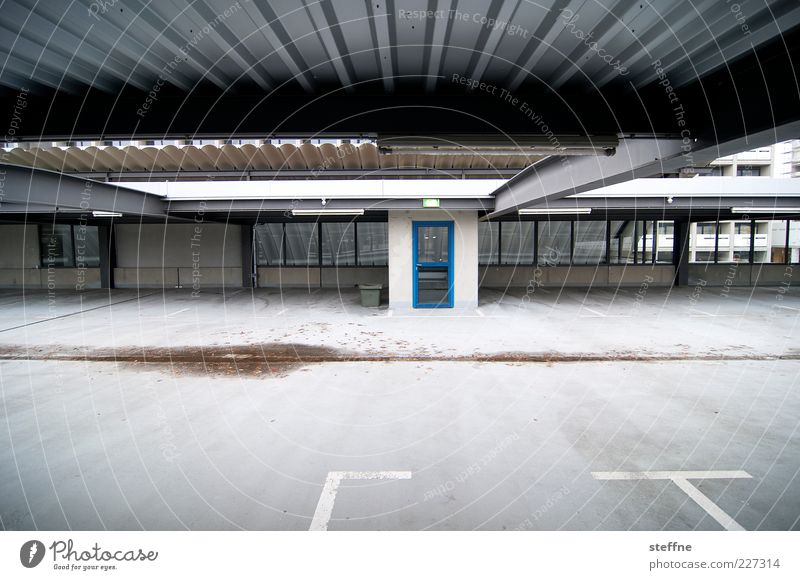 into the blue Door Town Empty Uninhabited Parking garage Colour photo Exterior shot Copy Space bottom Wide angle Lane markings Parking lot Corrugated sheet iron