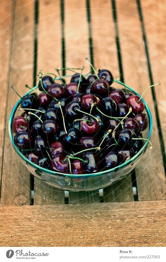 Delicious cherries Food Fruit Nutrition Vegetarian diet Bowl Summer To enjoy Fresh Healthy Cherry Glass bowl Wooden table Teak Colour photo Exterior shot