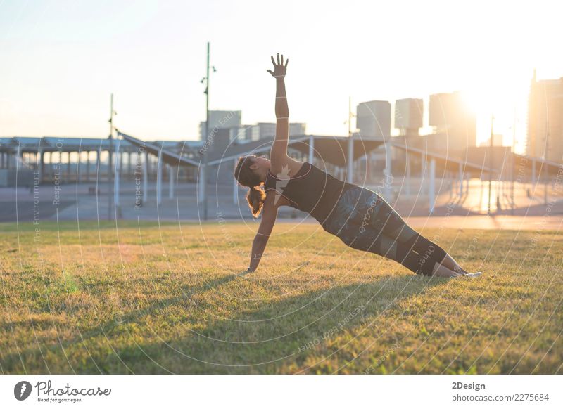 Beautiful girl is engaged in yoga in the park Lifestyle Harmonious Relaxation Sports Yoga Woman Adults Youth (Young adults) Nature Grass Park Sit Green Power