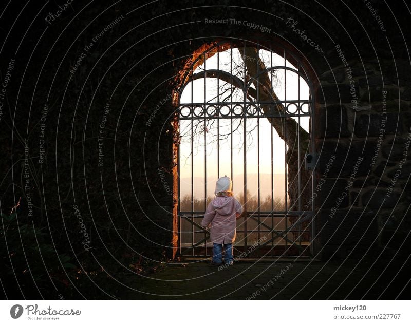 Girl at the gate Joy Happy Trip Far-off places Freedom Hiking Child Toddler Infancy 1 Human being 1 - 3 years Sky Sunlight Winter Tree Park Castle Door Gate