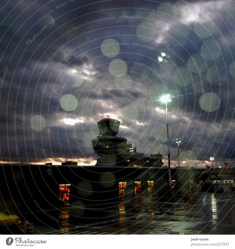 Otto Lilienthal is in the rain Drops of water Rain Airport Berlin-Tegel Airfield Air Traffic Control Tower Glittering Illuminate Dark Moody Lovesickness Longing