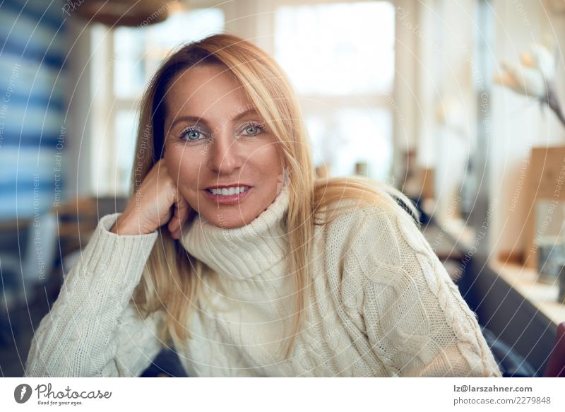 Portrait of a beautiful woman looking at camera Drinking Coffee Tea Pot Happy Beautiful Face Calm Leisure and hobbies Winter Table Woman Adults 1 Human being