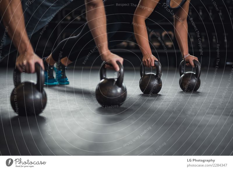 Athlete woman and man doing push ups on two kettlebells. Body Sports Human being Man Adults Building Fitness Muscular Natural Strong Power Energy Competition