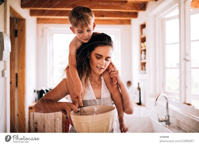 Mother and son baking together in kitchen Winter Kitchen Parenting Child Toddler Boy (child) Parents Adults Family & Relations Infancy Hut Smiling Together kids