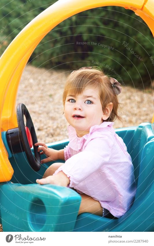 Happy little girl playing with a toy car Lifestyle Joy Wellness Well-being Playing Children's game Parenting Schoolyard Human being Feminine Toddler Girl