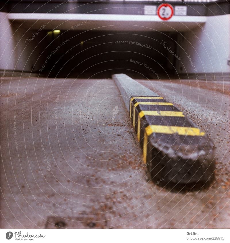 gullet Deserted Parking garage Street Concrete Signs and labeling Dark Gray Underground garage Highway ramp (entrance) Asphalt Warning label Colour photo