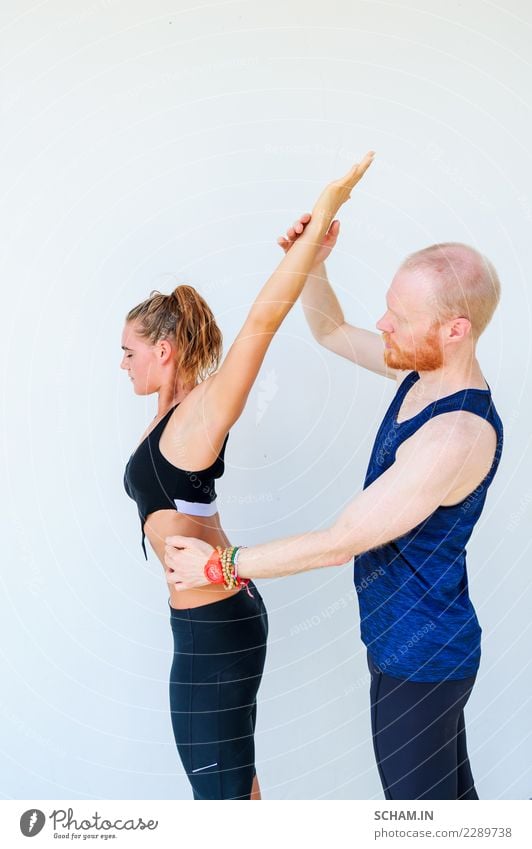 Yoga students showing different yoga poses. Arm raised. Teacher helps Lifestyle Health care Fitness Relaxation Calm Meditation Sports Human being Young woman