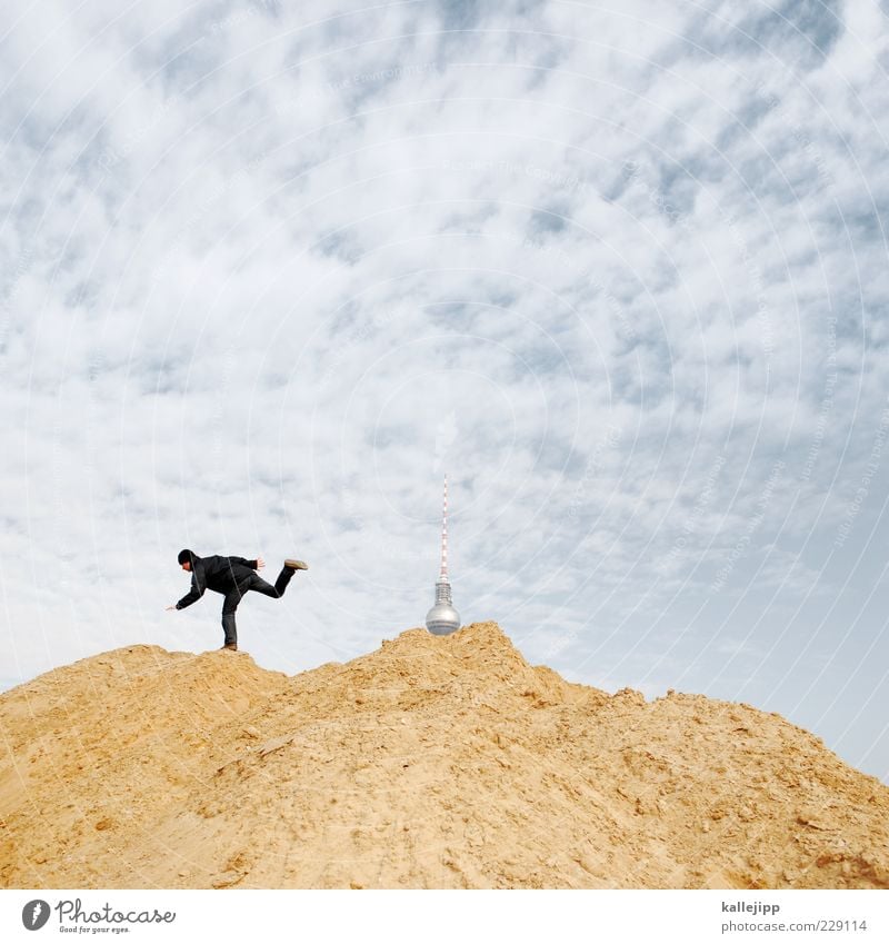 mud battle for dr. googleberg Construction site Human being Masculine Man Adults 1 Running Berlin Television tower Hip & trendy Clouds Sand Heap Colour photo