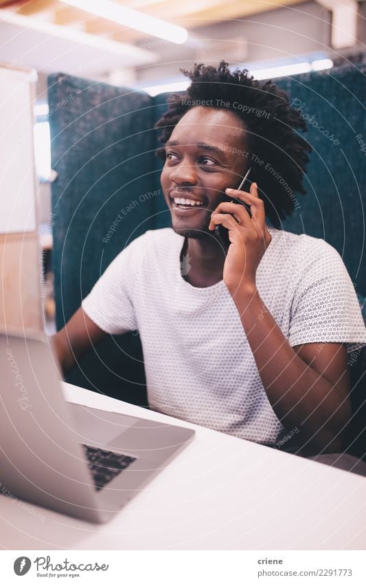 African American adult speaking on the phone at work Happy Work and employment Profession Office To talk PDA Notebook Technology Man Adults Youth (Young adults)