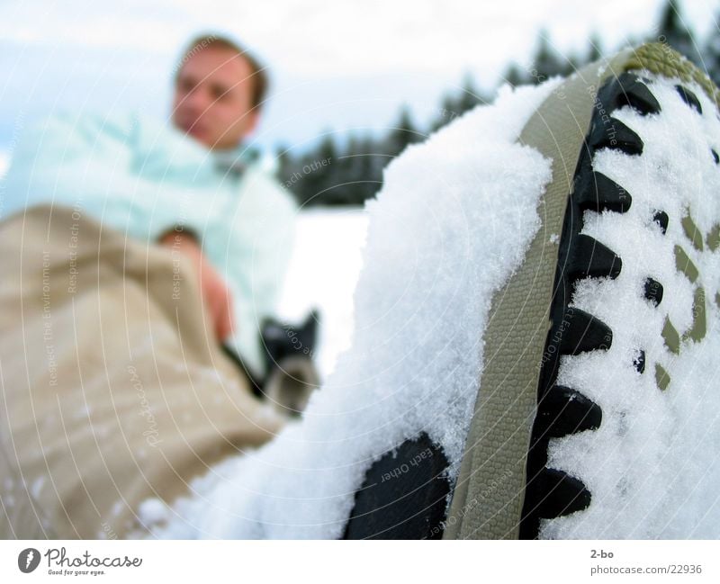 A day in the snow Snow Jonny Shallow depth of field Winter sportswear Winter clothing Anonymous Lie Exterior shot Colour photo Snowboarder Shoe sole Rough Burl