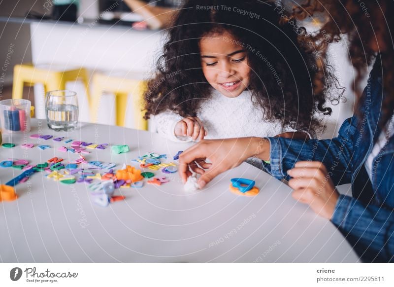 Little african girl playing with clay at home Joy Happy Playing Table Kindergarten Child School Woman Adults Parents Mother Family & Relations Infancy Paper Pen