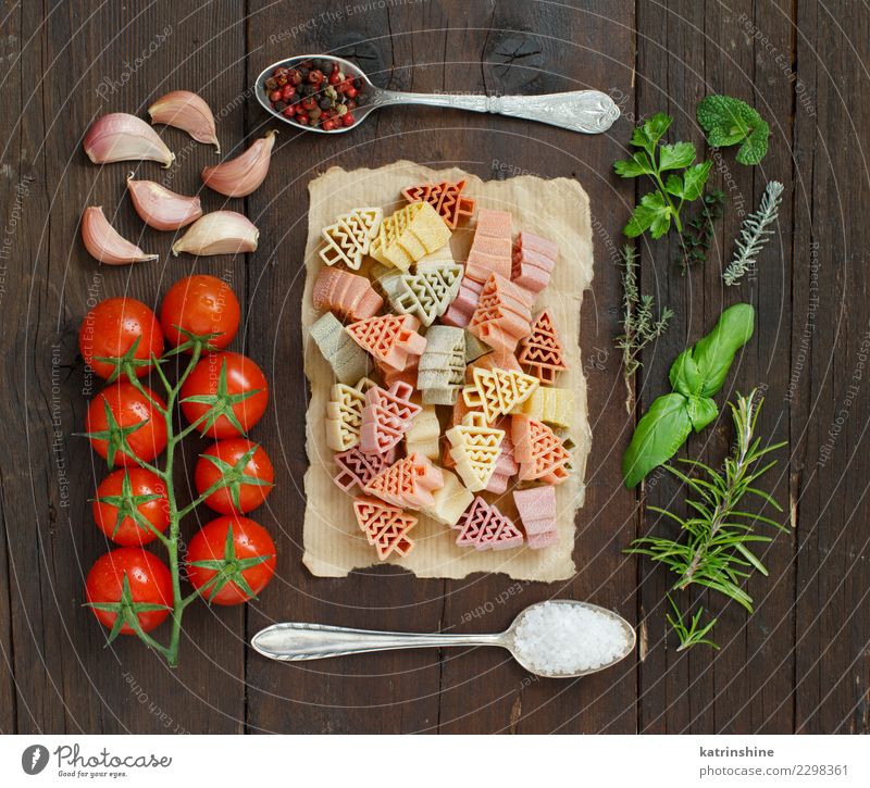 Tricolor pasta, vegetables and herbs on a wooden background Vegetable Vegetarian diet Diet Spoon Table Tree Dark Fresh Brown Green Red Tradition cooking food