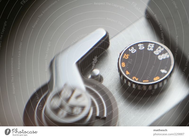 instant Camera Metal Black Silver Analog Photography Subdued colour Interior shot Detail Experimental Neutral Background Shallow depth of field Wheel