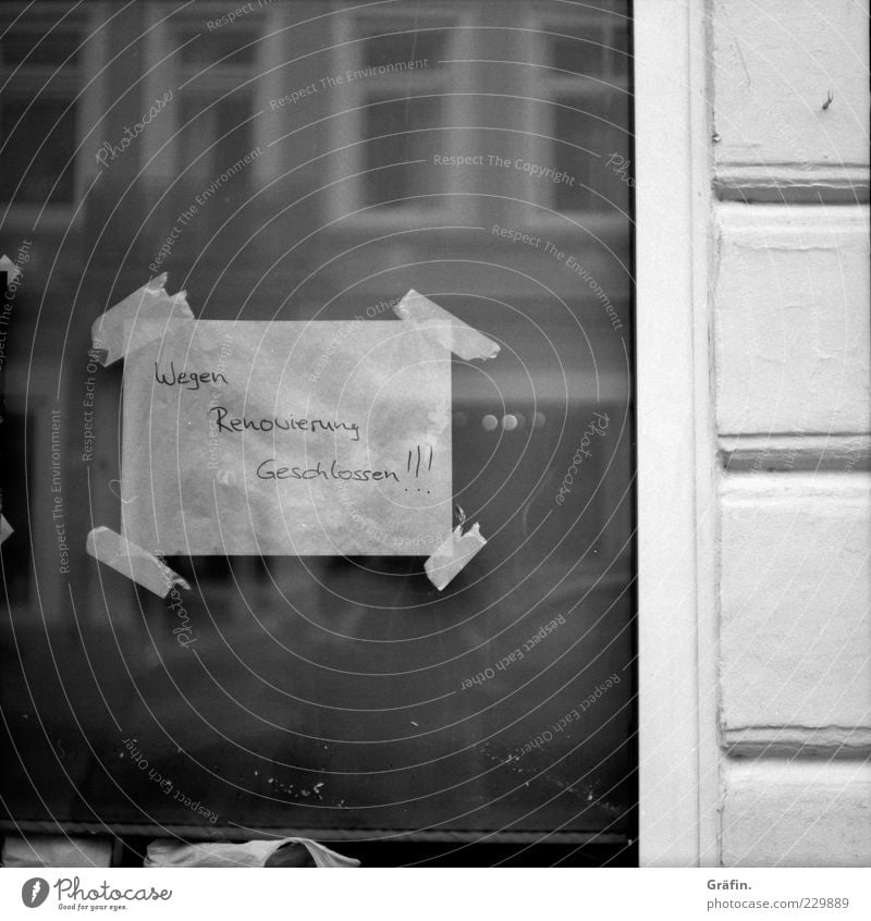 Closed for renovation Facade Window Characters Signs and labeling Old Dirty Simple Trashy Gray Black White Window pane Clue Letters (alphabet) Mirror image