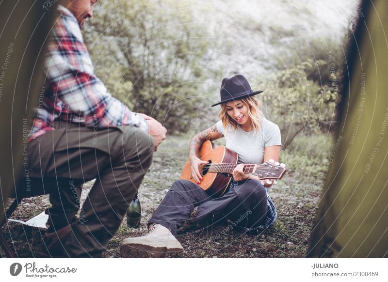 Young camping couple having a good time with guitar music Lifestyle Vacation & Travel Trip Adventure Far-off places Freedom Camping Mountain Hiking Human being