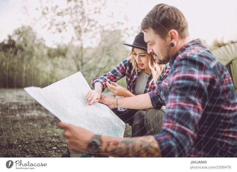 Young camping couple in nature searching way on map Lifestyle Vacation & Travel Trip Adventure Far-off places Freedom Camping Mountain Hiking Human being Couple