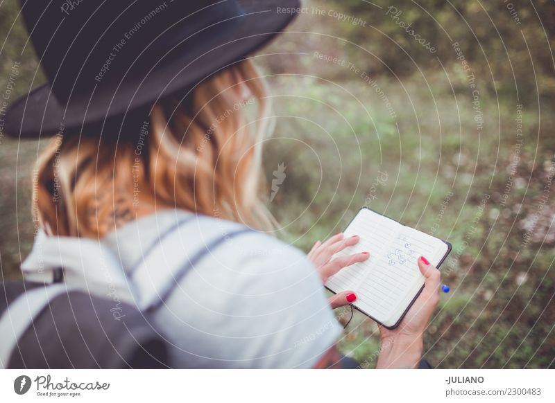 Young hiking woman taking notes in the nature Lifestyle Vacation & Travel Trip Adventure Far-off places Freedom Camping Mountain Hiking Human being Couple