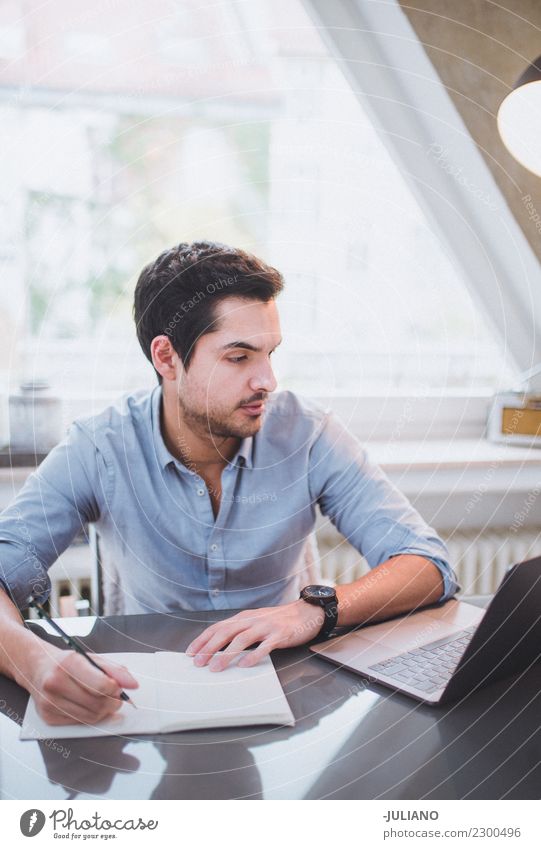 Young businessman with computer writing down notes Communicate Financial Industry Businessman Observe Work and employment Notebook Professional Success Office