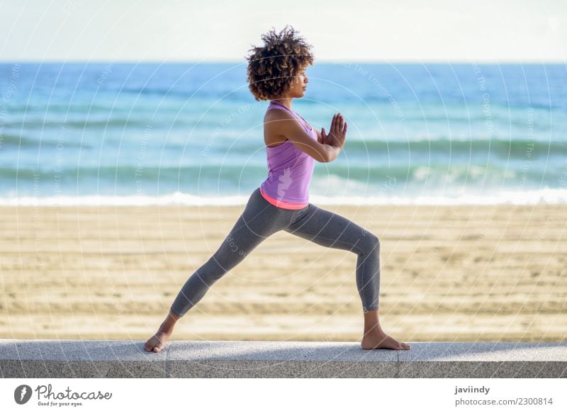 Black woman, afro hairstyle, doing yoga in the beach. Lifestyle Beautiful Body Hair and hairstyles Wellness Relaxation Meditation Leisure and hobbies Beach