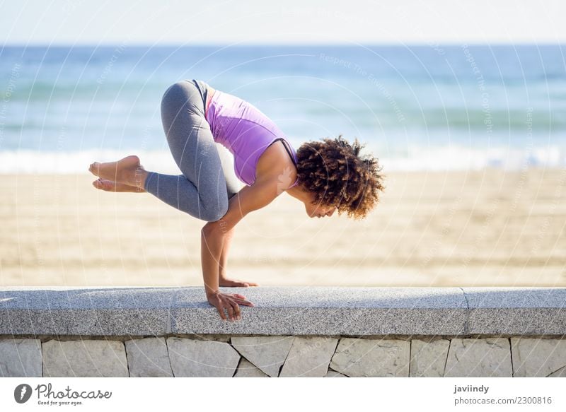 Black woman, afro hairstyle, doing yoga in the beach. Lifestyle Beautiful Body Hair and hairstyles Wellness Relaxation Meditation Leisure and hobbies Beach