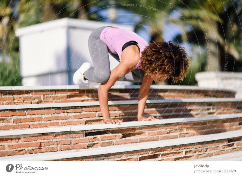 Black fit woman doing fitness acrobatics in the street Lifestyle Beautiful Body Hair and hairstyles Leisure and hobbies Sports Yoga Human being Young woman