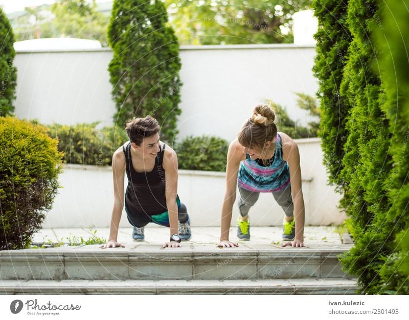 Couple of girls doing push ups Lifestyle Beautiful Body Sports Yoga Human being Woman Adults Fitness Smiling Athletic Friendliness Happiness Energy Teamwork