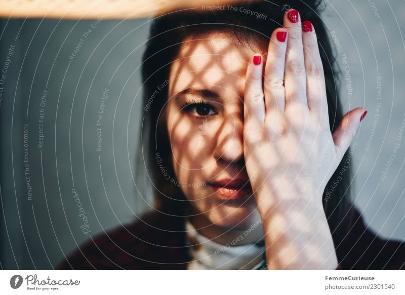 Young woman with shadow play on her face Feminine Youth (Young adults) Woman Adults 1 Human being 18 - 30 years Detail of face Concealed Hand Reflection