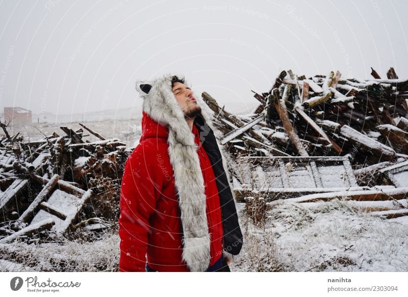 Young man with a fur hat enjoying a snowy day Lifestyle Style Joy Wellness Harmonious Winter Snow Winter vacation Human being Masculine Youth (Young adults) Man