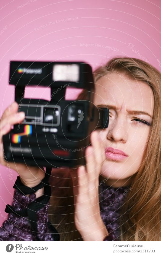 Young woman taking pictures with an instant camera Feminine Youth (Young adults) Woman Adults 1 Human being 18 - 30 years Creativity Instant camera Polaroid