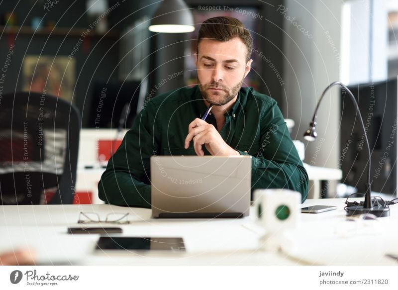 Young man studying with laptop computer on white desk. Lifestyle Happy School Study Academic studies Work and employment Business Computer Notebook Technology