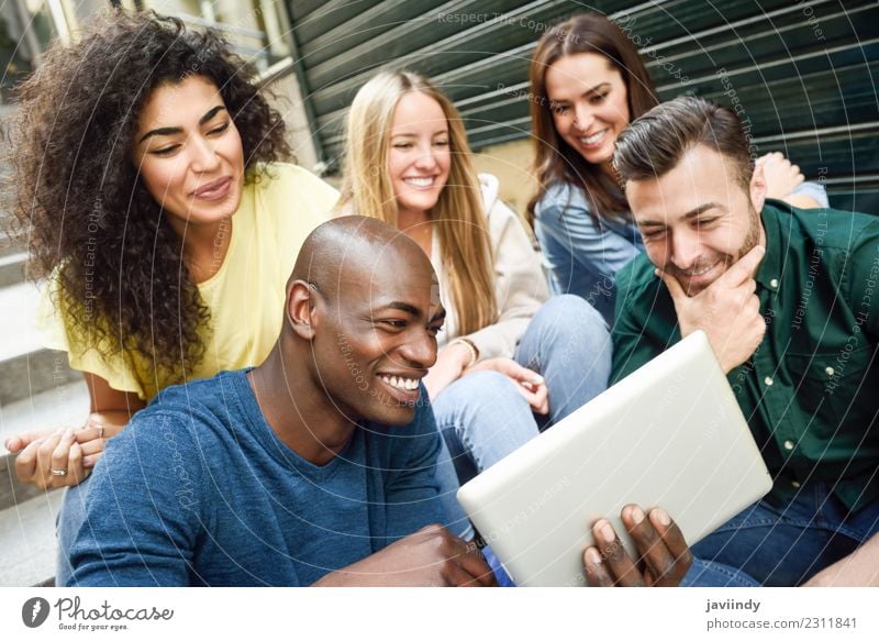 Multi-ethnic group of young people looking at a tablet computer outdoors Lifestyle Joy Happy Beautiful Young woman Youth (Young adults) Young man Woman Adults